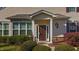 Inviting home entrance with sidelights, an oval window, and manicured shrubs at 617 Sealine Dr, Cary, NC 27519