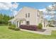Suburban townhome featuring manicured landscaping and a screened porch at 617 Sealine Dr, Cary, NC 27519