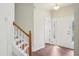 Bright foyer showcasing hardwood floors, and a staircase with a wood banister at 617 Sealine Dr, Cary, NC 27519