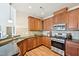 Modern kitchen featuring stainless steel appliances, granite countertops, and wood cabinets for storage at 617 Sealine Dr, Cary, NC 27519