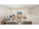 Upstairs loft seating area with comfortable sofa, armchairs, and a modern glass coffee table at 617 Sealine Dr, Cary, NC 27519