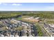 Gorgeous aerial view highlighting the community with school, green spaces, and ponds providing serene views at 6511 Academic Ave, Raleigh, NC 27616