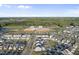 Aerial view showcasing the neighborhood and nearby school, surrounded by lush green trees and blue sky at 6511 Academic Ave, Raleigh, NC 27616