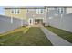 Backyard featuring a pergola covered patio with grill, fenced yard with grass, and a view of home's exterior at 6511 Academic Ave, Raleigh, NC 27616