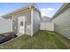 Backyard featuring a fenced yard with grass, and a view of the garage and home's exterior at 6511 Academic Ave, Raleigh, NC 27616