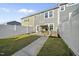 Backyard featuring a pergola covered patio with grill, fenced yard with grass, and a view of home's exterior at 6511 Academic Ave, Raleigh, NC 27616