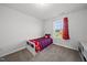 Cozy bedroom with a single bed, carpeted floor, and natural light from the window at 6511 Academic Ave, Raleigh, NC 27616