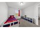 Comfortable bedroom with a twin bed, carpeted floor, and a modern storage unit at 6511 Academic Ave, Raleigh, NC 27616