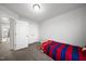 A cozy bedroom with carpet, white trim, and a view to the hallway at 6511 Academic Ave, Raleigh, NC 27616