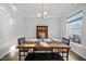 Inviting dining area with a rustic wooden table, bench seating, and decoratively set places near a window at 6511 Academic Ave, Raleigh, NC 27616