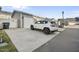 Large driveway featuring a view of the garage and a white Jeep Compass parked in front of the garage at 6511 Academic Ave, Raleigh, NC 27616