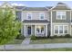 Charming townhouse with a welcoming front porch and rocking chairs, complemented by well-manicured landscaping at 6511 Academic Ave, Raleigh, NC 27616