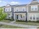 Inviting townhouse front view featuring a cozy porch with rocking chairs and neat landscaping at 6511 Academic Ave, Raleigh, NC 27616
