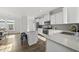 Bright, spacious kitchen with white cabinets, stainless steel appliances, and a kitchen island with bar stool seating at 6511 Academic Ave, Raleigh, NC 27616