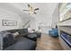 Bright living space featuring hardwood floors, a plush sectional, and a modern fireplace at 6511 Academic Ave, Raleigh, NC 27616