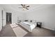 Neutral main bedroom featuring large window, ceiling fan and tray ceiling at 6511 Academic Ave, Raleigh, NC 27616
