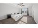 Spacious main bedroom with a tray ceiling, ceiling fan, large window, and neutral decor at 6511 Academic Ave, Raleigh, NC 27616