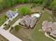 Aerial view of a large property featuring a swimming pool, lush landscaping, and multiple homes with ample space at 6512 Southern Times Dr, Raleigh, NC 27603