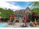 Spacious backyard with swimming pool, sun loungers, and a covered patio for outdoor entertaining at 6512 Southern Times Dr, Raleigh, NC 27603