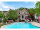 Expansive backyard features a pool, hot tub, patio area, and beautifully landscaped gardens at 6512 Southern Times Dr, Raleigh, NC 27603
