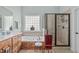 Well-lit bathroom featuring a soaking tub, separate shower, and tiled flooring for a relaxing experience at 6512 Southern Times Dr, Raleigh, NC 27603