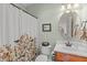 Charming bathroom with floral shower curtain, decorative mirror, and a classic sink and vanity at 6512 Southern Times Dr, Raleigh, NC 27603