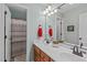 Inviting bathroom with double sinks, light-blue walls and neutral toned tiling in shower at 6512 Southern Times Dr, Raleigh, NC 27603