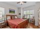 Comfortable bedroom featuring a wooden bed frame, hardwood floors, natural light, and a cozy atmosphere at 6512 Southern Times Dr, Raleigh, NC 27603