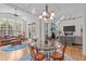 Elegant dining room showcases a glass table, decorative chandelier, and seamless flow to the living spaces at 6512 Southern Times Dr, Raleigh, NC 27603