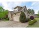 Exterior showcasing a spacious three car garage, well maintained landscaping, and beautiful architectural details at 6512 Southern Times Dr, Raleigh, NC 27603