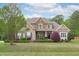 Inviting two-story home features a mix of stone and siding with a beautifully landscaped front yard at 6512 Southern Times Dr, Raleigh, NC 27603