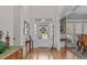 Bright foyer with hardwood floors, white trim, and transom windows offers a welcoming entrance at 6512 Southern Times Dr, Raleigh, NC 27603