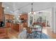 Open-concept kitchen and breakfast area featuring wood cabinets, an island, and natural light at 6512 Southern Times Dr, Raleigh, NC 27603