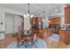 Well-appointed kitchen with wood cabinets, an island, and an adjacent breakfast area at 6512 Southern Times Dr, Raleigh, NC 27603