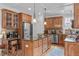 Gourmet kitchen boasts custom wood cabinets, granite countertops, stainless steel appliances and a center island at 6512 Southern Times Dr, Raleigh, NC 27603