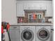 Well-organized laundry room features granite countertops, washer, dryer, and ample cabinet space at 6512 Southern Times Dr, Raleigh, NC 27603