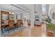 Open-concept living room with hardwood floors, fireplace, and views into the dining room and kitchen at 6512 Southern Times Dr, Raleigh, NC 27603