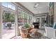 Charming sunroom with large windows, comfortable seating, and a ceiling fan at 6512 Southern Times Dr, Raleigh, NC 27603