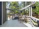 Lovely back deck with white pergola, string lights, and table and chairs overlooking a wooded lot at 7 Wythebrook Ln, Durham, NC 27713