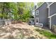 Fenced backyard features a hot tub and deck area with patio for grilling and entertaining guests at 7 Wythebrook Ln, Durham, NC 27713