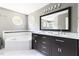 Bathroom featuring double vanity, soaking tub, and octagon windows at 7 Wythebrook Ln, Durham, NC 27713