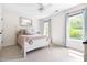 Light and airy bedroom featuring large windows and pastel decor at 7 Wythebrook Ln, Durham, NC 27713