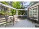 Outdoor deck with string lights, dining set, and bench, perfect for entertaining at 7 Wythebrook Ln, Durham, NC 27713