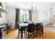 Elegant dining room with hardwood floors, a chandelier, and a view of the outdoor greenery at 7 Wythebrook Ln, Durham, NC 27713