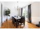 Elegant dining room with hardwood floors, a chandelier, and a view of the outdoor greenery at 7 Wythebrook Ln, Durham, NC 27713