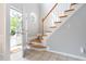 Inviting foyer with staircase featuring wood treads and white risers, leading to the upper level at 7 Wythebrook Ln, Durham, NC 27713