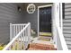 Close-up of a stylish front door with a decorative window and white railing at 7 Wythebrook Ln, Durham, NC 27713