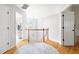Upstairs hallway with hardwood floors and natural light at 7 Wythebrook Ln, Durham, NC 27713