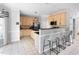 Open kitchen with light wood cabinets, stainless steel appliances, and a breakfast bar at 7 Wythebrook Ln, Durham, NC 27713