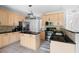 Bright, open kitchen with stainless steel appliances, an island, and granite countertops at 7 Wythebrook Ln, Durham, NC 27713
